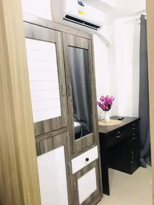 a sliding door with a mirror and a desk at Shore Residence Staycation unit at Mall of Asia in Manila