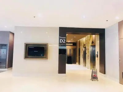 a lobby of a building with a sign on the wall at Shore Residence Staycation unit at Mall of Asia in Manila
