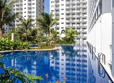 a large swimming pool in the middle of a building at Shore Residences MOA Complex Staycation in Manila