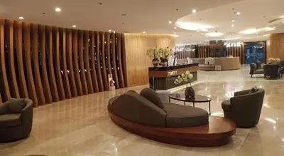 a lobby with a couch and chairs and a table at Shore Residences MOA Complex Staycation in Manila