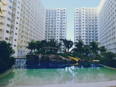 a pool of water in front of tall buildings at Shore Residences MOA Complex Staycation in Manila