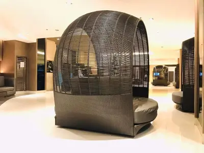 a bird cage sitting in the middle of a room at Condo- tel for At Mall of Asia Philippines in Manila