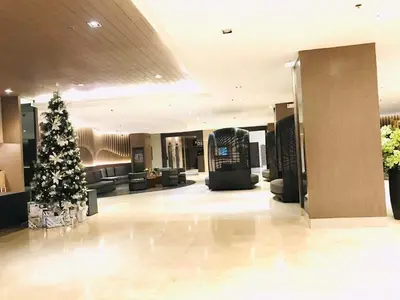 a christmas tree in the middle of a lobby at Condo- tel for At Mall of Asia Philippines in Manila