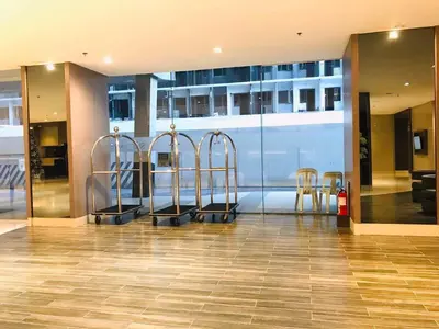 a lobby with three bar stools in a building at Condo- tel for At Mall of Asia Philippines in Manila