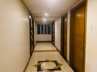 a hallway with a tile floor with the letter k on it at Morgan Suite BGC Shortwalk2 Venice Mall free pool gym in Manila