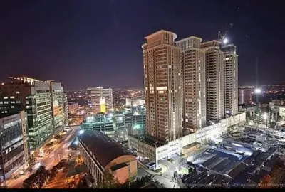 a city skyline with tall buildings at night at Morgan Suite BGC shortwalk1 Venice Mall free pool in Manila