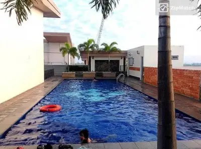 a swimming pool with a red frisbee in it at Morgan Suite BGC shortwalk1 Venice Mall free pool in Manila