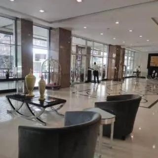 a lobby with chairs and a table in a building at Morgan Suite BGC shortwalk1 Venice Mall free pool in Manila