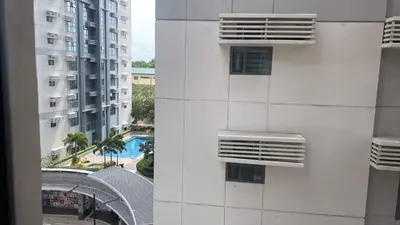 a view of a white building with a swimming pool at Morgan Suite BGC shortwalk1 Venice Mall free pool in Manila