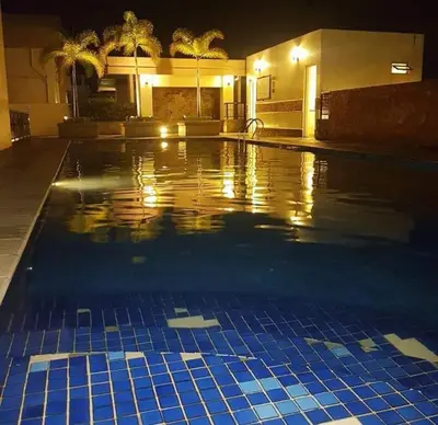 a swimming pool at night with blue tiles at Morgan Suite BGC shortwalk1 Venice Mall free pool in Manila