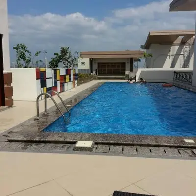 a large blue swimming pool in front of a building at Morgan Suite BGC Shortwalk3 Venice Mall free pool gym in Manila