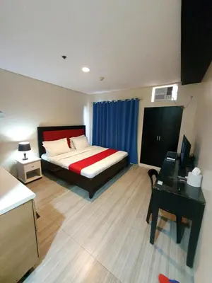 a hotel room with a bed and a desk and a desk at Sab R. Bel air soho in Manila