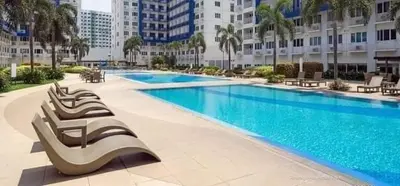 a large swimming pool in a large building at The FINEST Sea Residences Condo in Manila