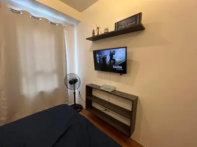 a room with a tv on a wall at The Cozy Place Condo in Pasig Phil in Manila