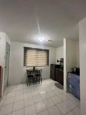 a living room with a table and a kitchen at San Jose Residencias / enchanted kingdom / nuvali / slex / sta. rosa / paseo in Santa Rosa