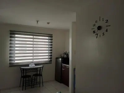 a kitchen with a window and a clock on the wall at San Jose Residencias / enchanted kingdom / nuvali / slex / sta. rosa / paseo in Santa Rosa
