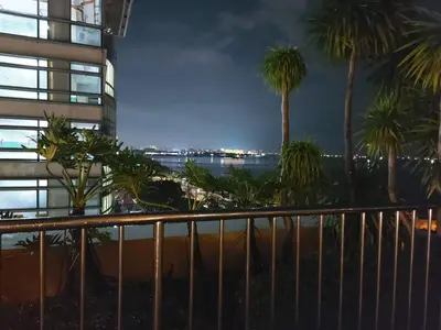 a view from the balcony of a building with palm trees at Comfy Condo Grand Riviera Suite, Roxas Blvd Ermita Manila infront of US Embassy in Manila