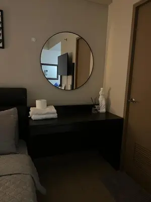 a room with a mirror and a bed and a bed sidx sidx sidx at Cozy condo near Airport Manila in Manila