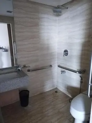 a bathroom with a shower with a toilet and a sink at Relaxing Big Studio Bedroom in Manila