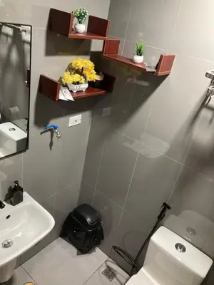 a bathroom with a white toilet and a sink at Makati amazing view Penthouse studio, Air Residence, fast internet in Manila