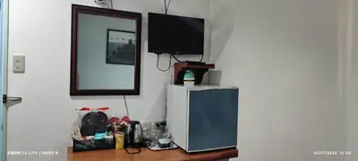 a television sitting on top of a refrigerator at duck inn manila in Manila
