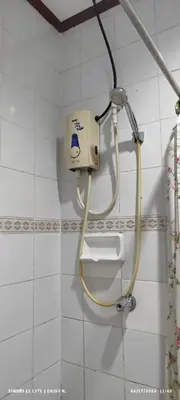 a bathroom with a soap dispenser on a wall at duck inn manila in Manila