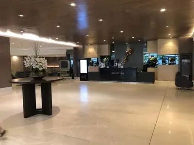 a lobby with a table in the middle of a building at 1 Bedroom lovely place near Mall of Asia in Manila