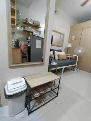 a small living room with a table and a mirror at 821 Field Res Condo by Bambie with 2 wifi in Manila