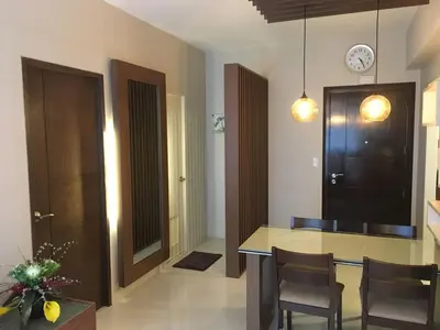 a kitchen with a table and chairs and a clock on the wall at 2 BR Condo Apartment near NAIA 3 Pasay City in Manila