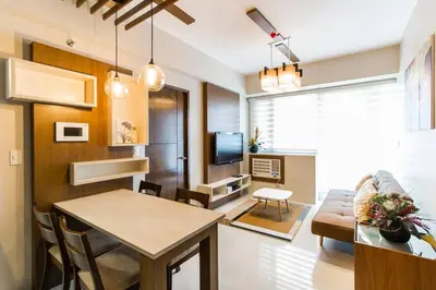 a living room with a couch and a table at 2 BR Condo Apartment near NAIA 3 Pasay City in Manila