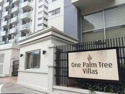 a one palm tree villas sign in front of a building at 2 BR Condo Apartment near NAIA 3 Pasay City in Manila