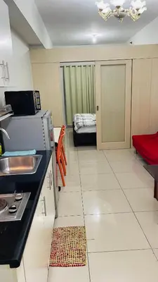 a kitchen with a sink and a stove in a room at Destina Stays @Jazz Residences, Makati, Metro Manila, w/Netflix in Manila
