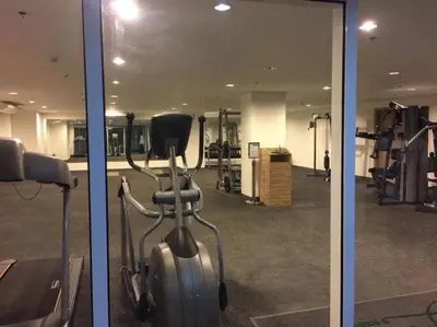 two pictures of a gym with a treadmill at Affordable Fully Furnished Condo Unit in Manila