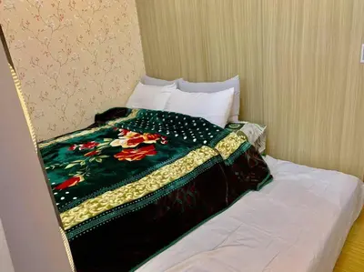 a bed with a colorful blanket on top of it at Affordable Fully Furnished Condo Unit in Manila