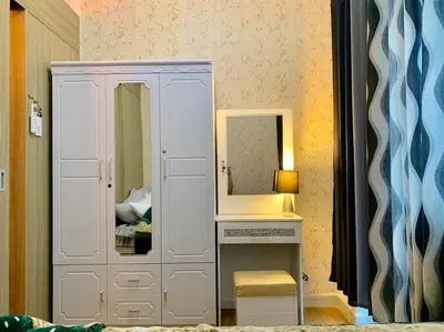 a white cabinet with a mirror and a lamp at Affordable Fully Furnished Condo Unit in Manila