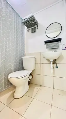 a bathroom with a toilet and a sink at Staycation in Pasig - Near SM East Ortigas in Manila