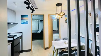 a kitchen and dining room with a table and chairs at Staycation in Pasig - Near SM East Ortigas in Manila