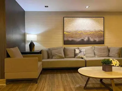 a living room with a couch and a table at Modern Classic 1 BR Condo Air Residences Makati in Manila