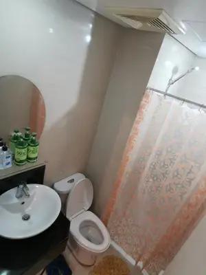a bathroom with a toilet and a sink at Staycation @150 Newport pasay city in Manila