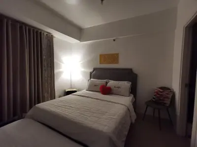 a bedroom with a bed with a red heart on it at Staycation @150 Newport pasay city in Manila