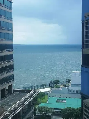 a view of the ocean from a building at Grand riviera suites Studio Type Only in Manila