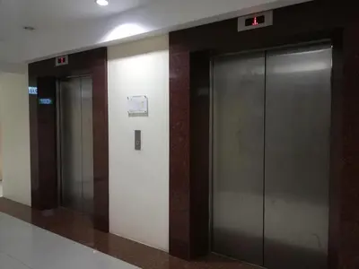 three elevators in a building with their doors open at Grand riviera suites Studio Type Only in Manila