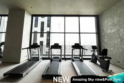 a gym with several treadmills and a large window at Century Spire Makati in Manila