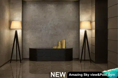 two lamps in a room with a black dresser at Century Spire Makati in Manila
