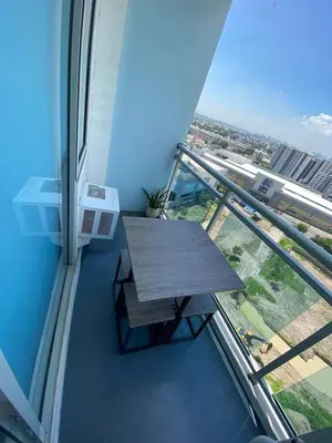a balcony with a wooden table in a building at The Carribean Suites by Azure in Manila