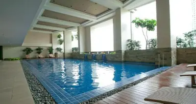 a large swimming pool in a hotel room at Sky Staycation KL Greenbelt, Isabel's Makati Rooms in Manila