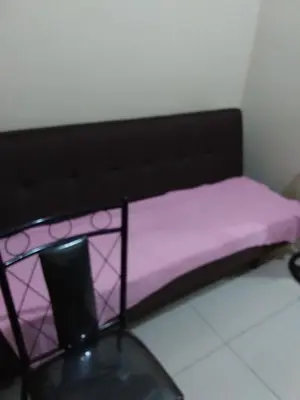 a bed in a room with a purple mattress at Condo at Shell Residences in Manila