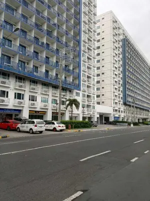 a parking lot in front of a large building at Sea Residences Tower F in Manila