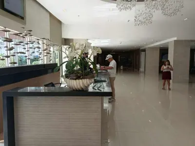 a man standing in the lobby of a building at Sea Residences Tower F in Manila