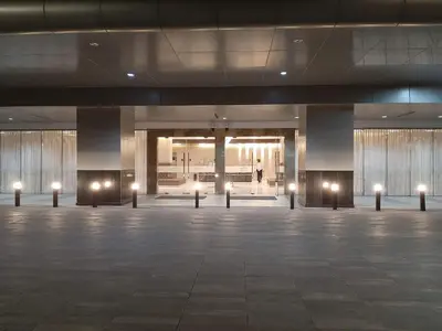 an empty lobby with lights in the middle of a building at Shore 3 Residences Mall of Asia Pool view Netflix free wifi in Manila